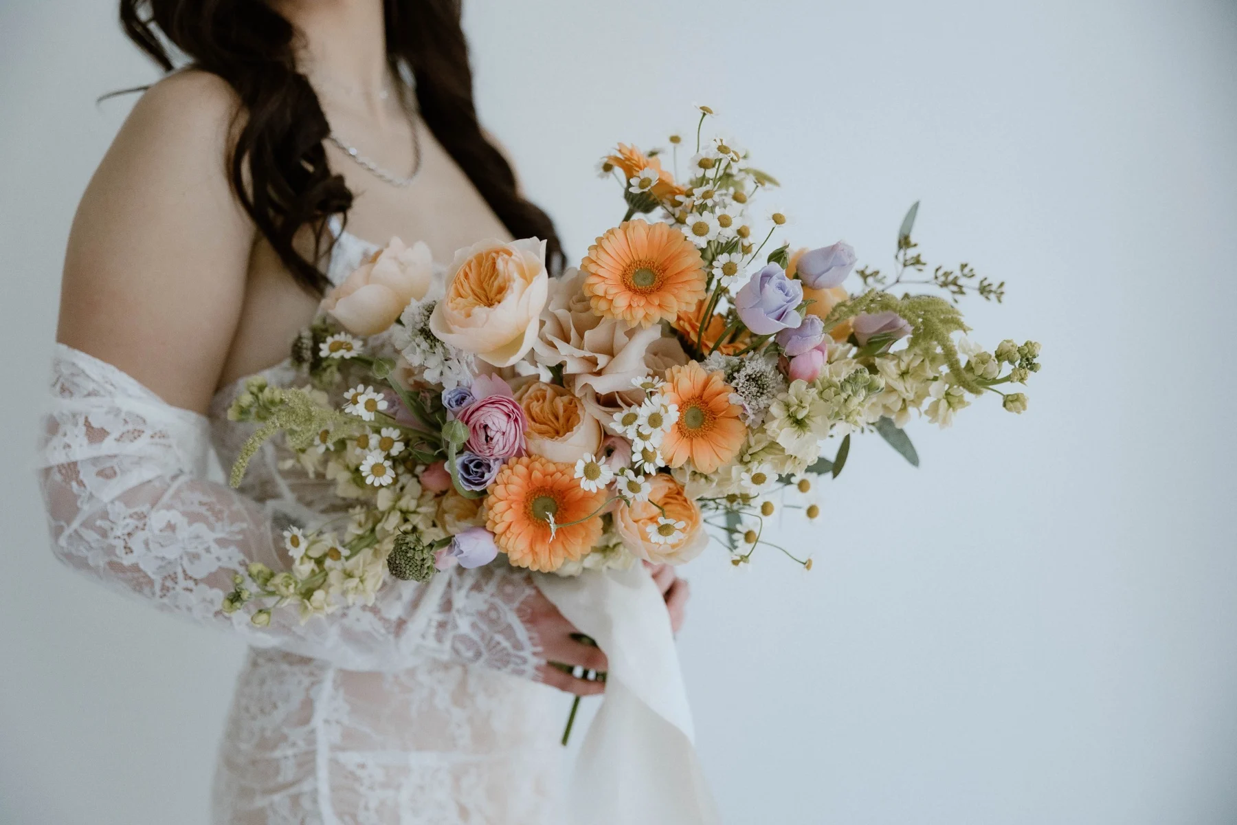 Airy peach and cream bridal bouquet with delicate lilac flowers
